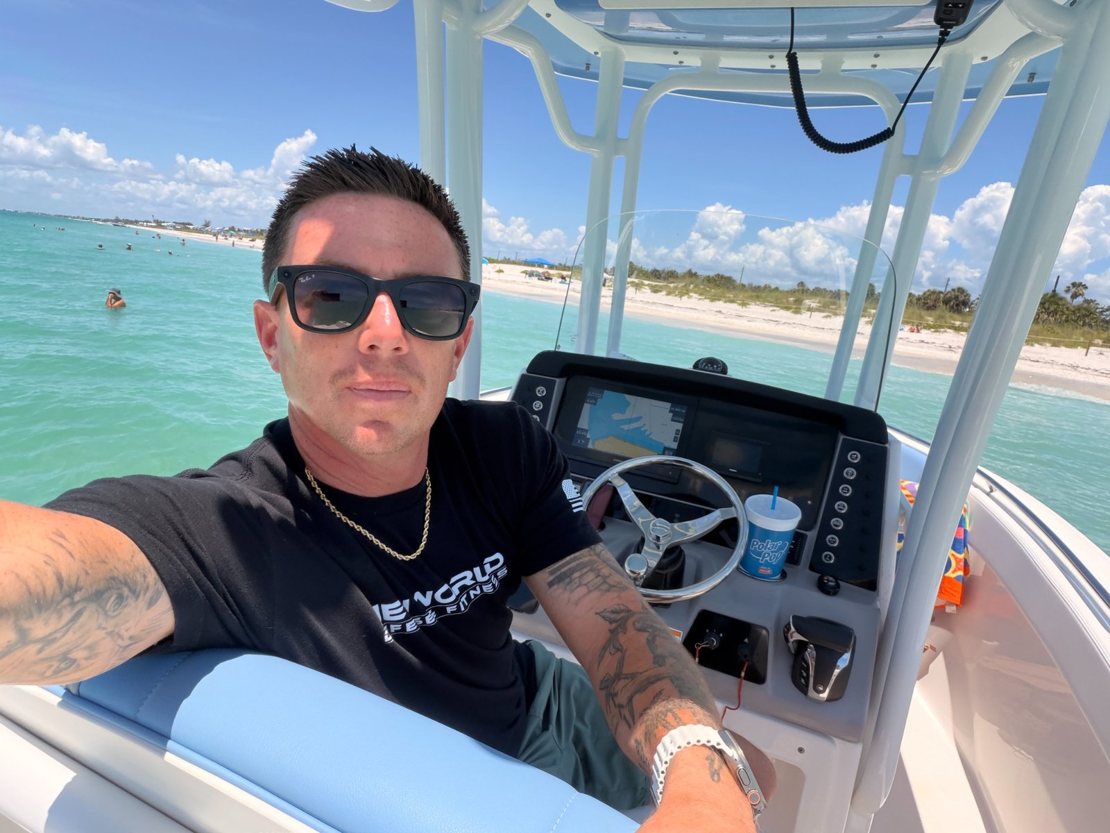 Captain James Douvia at the boat helm in turquoise Florida water